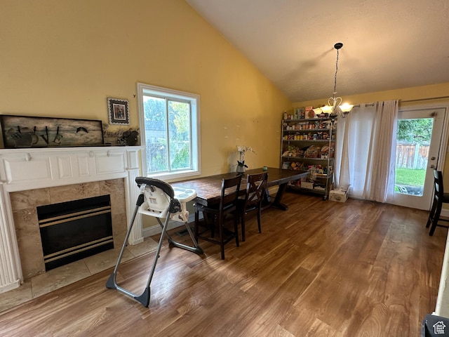 83 E 1820 S, Orem, UT 84058 - dining space with a chandelier, wood finished floors, vaulted ceiling, plenty of natural light, and a tile fireplace