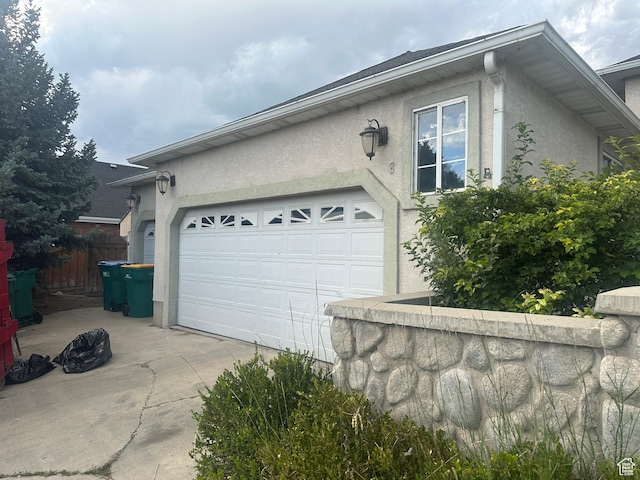 83 E 1820 S, Orem, UT 84058 - view of side of property with stucco siding, driveway, and an attached garage