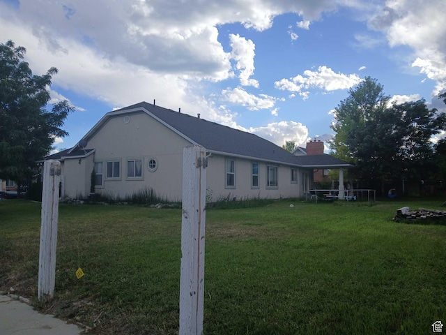 83 E 1820 S, Orem, UT 84058 - view of home's exterior with a yard, a chimney, and stucco siding