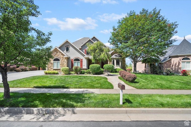 1711 N Compton Rd, Farmington, UT 84025 - view of front of house with stone siding, a front yard, and stucco siding