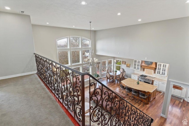 1711 N Compton Rd, Farmington, UT 84025 - stairs with recessed lighting, a chandelier, a high ceiling, and wood finished floors