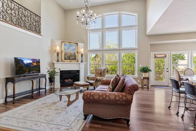 1711 N Compton Rd, Farmington, UT 84025 - living area featuring a chandelier, a towering ceiling, wood finished floors, and a glass covered fireplace