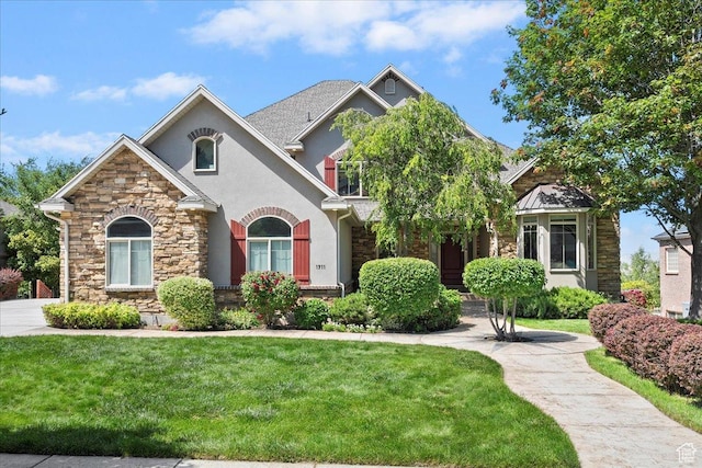1711 N Compton Rd, Farmington, UT 84025 - view of front of home with stone siding, stucco siding, and a front yard