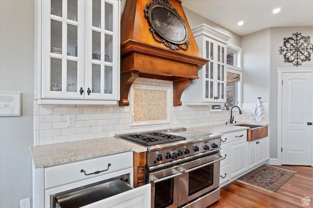 1711 N Compton Rd, Farmington, UT 84025 - kitchen with double oven range, white cabinets, light stone counters, wood finished floors, and tasteful backsplash