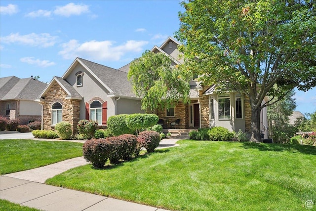 1711 N Compton Rd, Farmington, UT 84025 - view of front facade with stone siding, stucco siding, and a front lawn