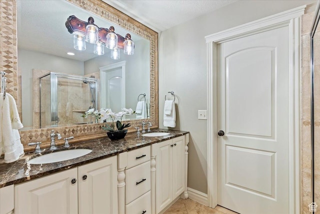1711 N Compton Rd, Farmington, UT 84025 - bathroom featuring a shower stall, double vanity, a textured ceiling, and tile patterned floors