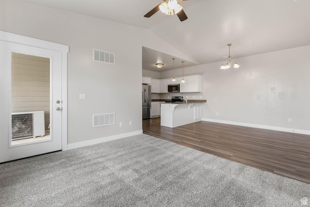 4234 W Mckellen Dr S Unit G301, Herriman, UT 84096 - unfurnished living room with lofted ceiling, ceiling fan, a chandelier, and dark carpet