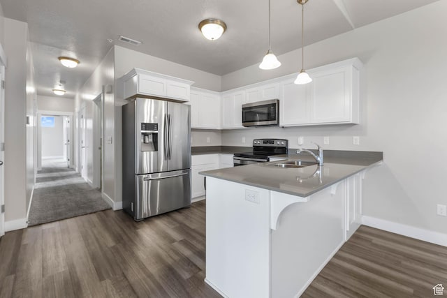 4234 W Mckellen Dr S Unit G301, Herriman, UT 84096 - kitchen with appliances with stainless steel finishes, a peninsula, dark wood finished floors, and white cabinets