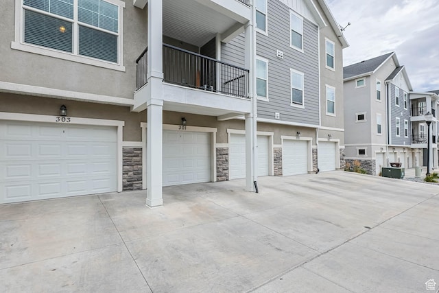 4234 W Mckellen Dr S Unit G301, Herriman, UT 84096 - view of property featuring an attached garage, driveway, and a residential view