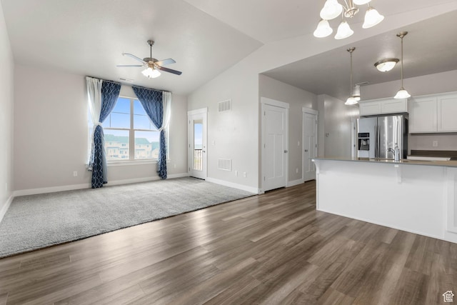 4234 W Mckellen Dr S Unit G301, Herriman, UT 84096 - unfurnished living room featuring ceiling fan, wood finished floors, lofted ceiling, and a chandelier
