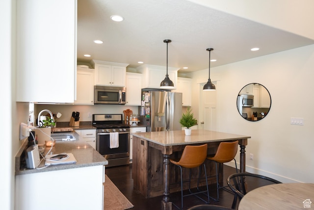 1090 E 770 S, Heber City, UT 84032 - kitchen featuring stainless steel appliances, recessed lighting, white cabinetry, a breakfast bar, and a center island
