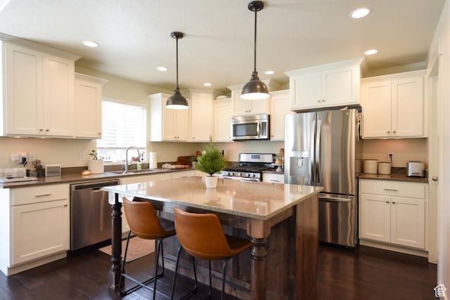 1090 E 770 S, Heber City, UT 84032 - kitchen with appliances with stainless steel finishes, dark wood-style flooring, a kitchen island, recessed lighting, and white cabinetry