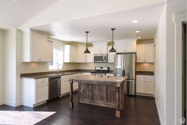 1090 E 770 S, Heber City, UT 84032 - kitchen with appliances with stainless steel finishes, dark countertops, dark wood-type flooring, white cabinetry, and recessed lighting