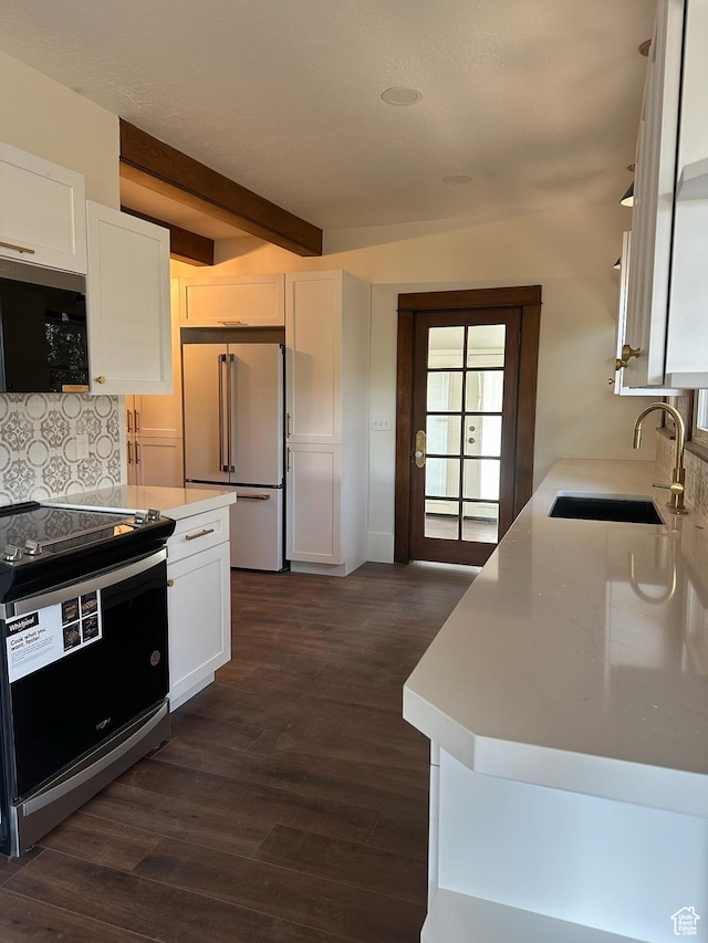 380 N K St, Salt Lake City, UT 84103 - kitchen featuring appliances with stainless steel finishes, beam ceiling, white cabinetry, light countertops, and dark wood-type flooring