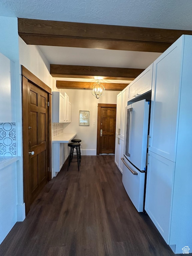 380 N K St, Salt Lake City, UT 84103 - kitchen featuring high end white refrigerator, beam ceiling, dark wood-style flooring, white cabinets, and light countertops