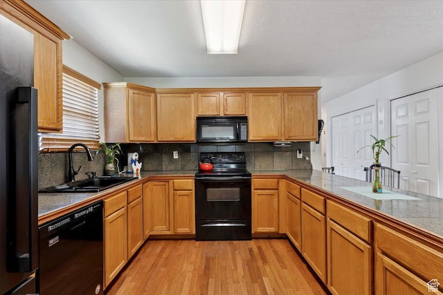 2793 S Cyprus Grove Cir W, Magna, UT 84044 - kitchen with black appliances, light wood finished floors, and backsplash