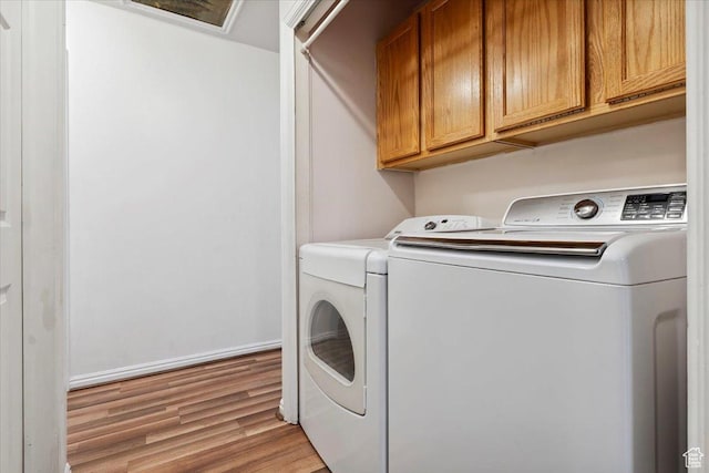 2793 S Cyprus Grove Cir W, Magna, UT 84044 - laundry room featuring washer and clothes dryer, light wood finished floors, and cabinet space