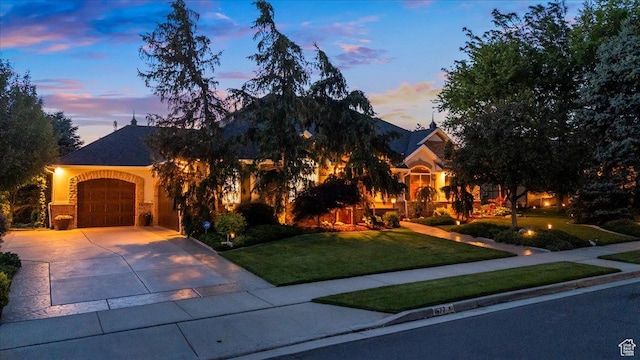 1677 E Wylie Ln, Draper, UT 84020 - view of property hidden behind natural elements featuring a front yard, concrete driveway, and an attached garage