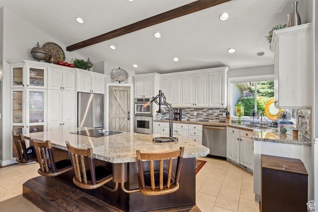 1677 E Wylie Ln, Draper, UT 84020 - kitchen with stainless steel appliances, decorative backsplash, white cabinets, a kitchen island with sink, and light stone countertops