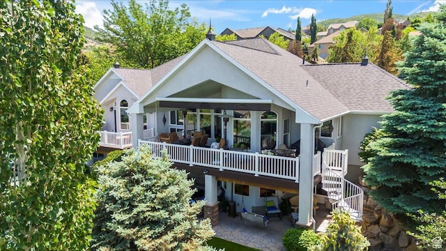 1677 E Wylie Ln, Draper, UT 84020 - back of property featuring stucco siding, roof with shingles, a wooden deck, and a patio area