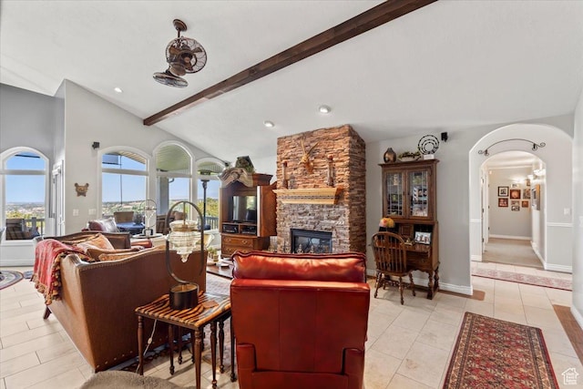 1677 E Wylie Ln, Draper, UT 84020 - living area featuring arched walkways, a stone fireplace, and light tile patterned floors