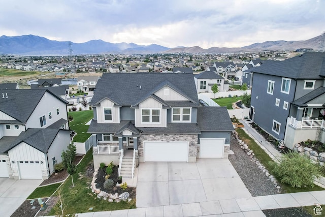 499 N Stone Ridge Dr, Saratoga Springs, UT 84045 - view of front of house featuring a residential view, driveway, stone siding, and a mountain view