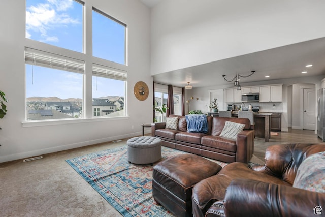 499 N Stone Ridge Dr, Saratoga Springs, UT 84045 - carpeted living area featuring a high ceiling and recessed lighting