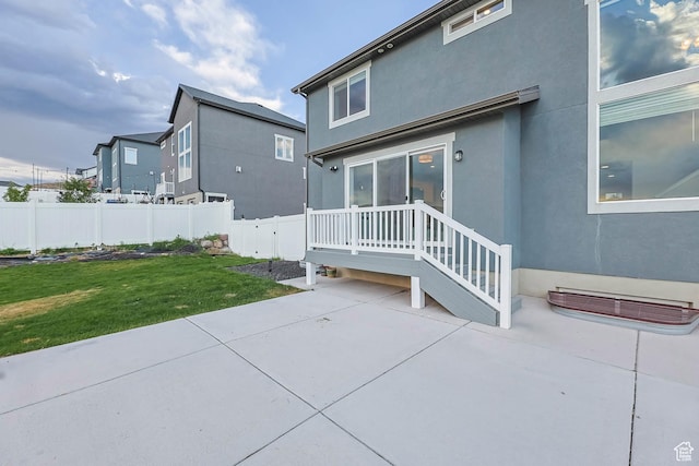 499 N Stone Ridge Dr, Saratoga Springs, UT 84045 - back of property with a patio area and stucco siding