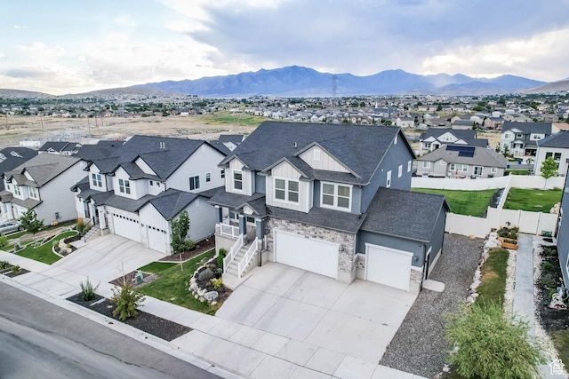 499 N Stone Ridge Dr, Saratoga Springs, UT 84045 - view of front of house featuring stone siding, a residential view, an attached garage, and driveway