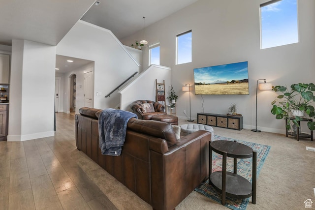 499 N Stone Ridge Dr, Saratoga Springs, UT 84045 - living room with a towering ceiling, arched walkways, stairs, and recessed lighting