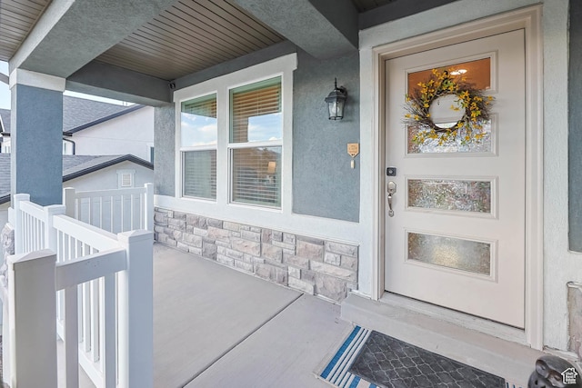499 N Stone Ridge Dr, Saratoga Springs, UT 84045 - doorway to property with covered porch, stone siding, and stucco siding
