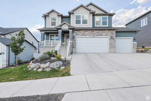 499 N Stone Ridge Dr, Saratoga Springs, UT 84045 - craftsman-style home with stone siding, covered porch, concrete driveway, board and batten siding, and a garage