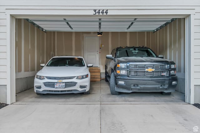 3444 Sparrow Ln W Unit 164, Eagle Mountain, UT 84005 - garage with driveway and a garage door opener