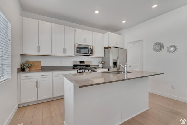 3444 Sparrow Ln W Unit 164, Eagle Mountain, UT 84005 - kitchen featuring stainless steel appliances, a kitchen island with sink, light wood finished floors, white cabinetry, and recessed lighting