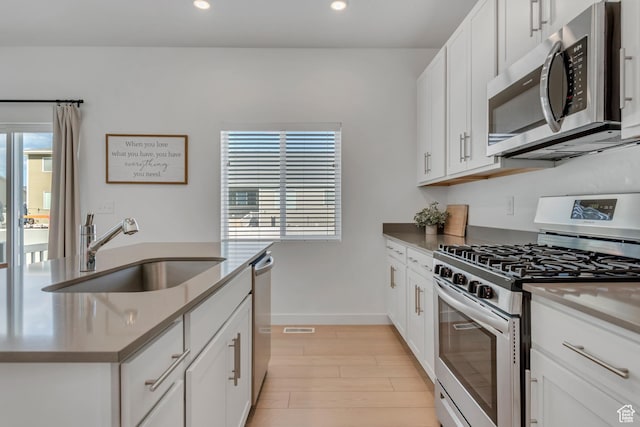 3444 Sparrow Ln W Unit 164, Eagle Mountain, UT 84005 - kitchen with appliances with stainless steel finishes, recessed lighting, light wood-style floors, and white cabinets