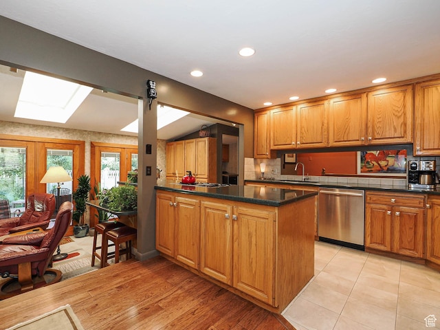 2680 E 2100th St S Unit 44-45, Salt Lake City, UT 84109 - kitchen with stainless steel dishwasher, a skylight, plenty of natural light, a peninsula, and recessed lighting