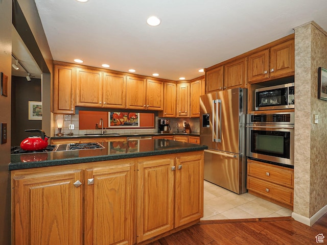 2680 E 2100th St S Unit 44-45, Salt Lake City, UT 84109 - kitchen with appliances with stainless steel finishes, a peninsula, light wood-type flooring, brown cabinetry, and recessed lighting