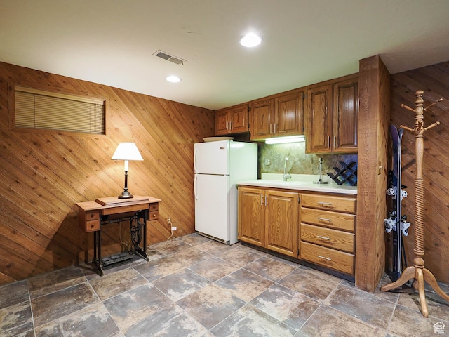 2680 E 2100th St S Unit 44-45, Salt Lake City, UT 84109 - kitchen featuring freestanding refrigerator, light countertops, stone tile floors, wooden walls, and recessed lighting