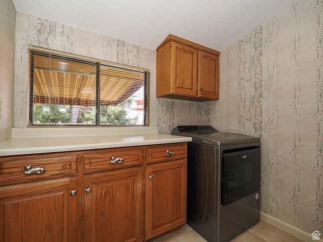 2680 E 2100th St S Unit 44-45, Salt Lake City, UT 84109 - laundry area featuring washer / dryer, cabinet space, healthy amount of natural light, wallpapered walls, and light tile patterned flooring