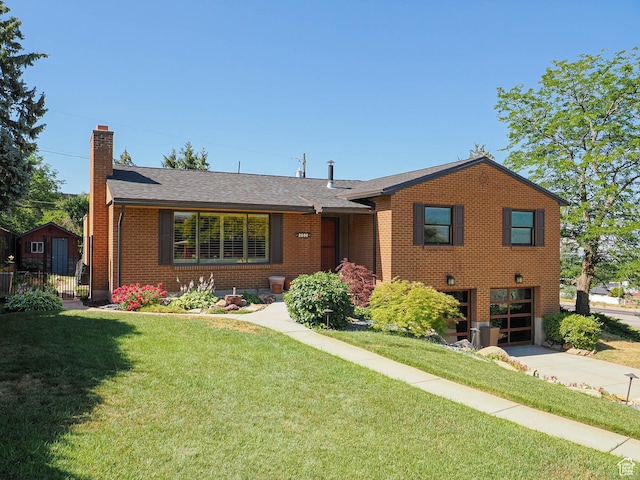 2680 E 2100th St S Unit 44-45, Salt Lake City, UT 84109 - view of front of property with a chimney, brick siding, driveway, an attached garage, and roof with shingles