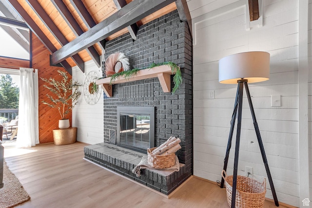 575 Upper Evergreen Dr, Park City, UT 84098 - living room with beamed ceiling, wood finished floors, wood walls, a brick fireplace, and high vaulted ceiling