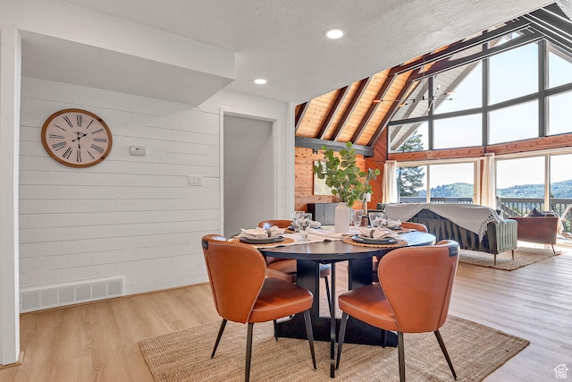 575 Upper Evergreen Dr, Park City, UT 84098 - dining area featuring wood walls, wood finished floors, high vaulted ceiling, and recessed lighting
