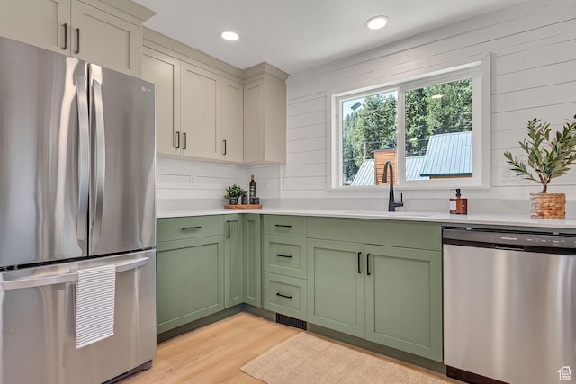 575 Upper Evergreen Dr, Park City, UT 84098 - kitchen featuring stainless steel appliances, green cabinetry, light countertops, recessed lighting, and wood walls