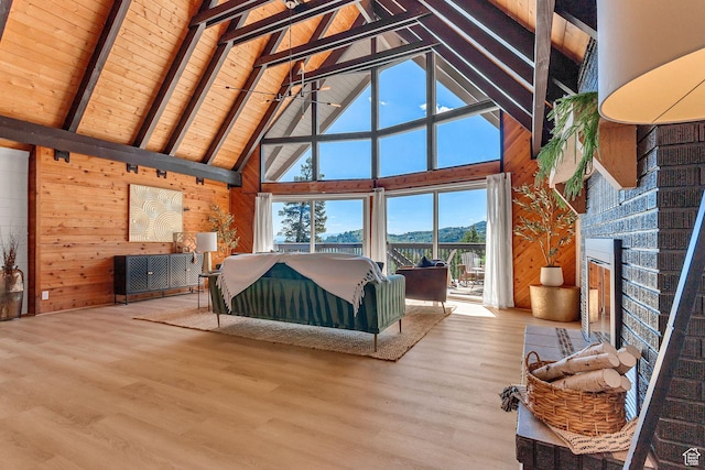 575 Upper Evergreen Dr, Park City, UT 84098 - living room with high vaulted ceiling, wood walls, a fireplace, wood finished floors, and a mountain view