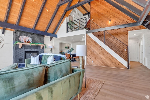575 Upper Evergreen Dr, Park City, UT 84098 - living room featuring high vaulted ceiling, wood finished floors, beamed ceiling, wood walls, and a fireplace