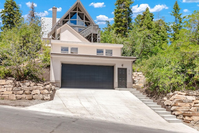575 Upper Evergreen Dr, Park City, UT 84098 - view of front of home featuring stairs, concrete driveway, an attached garage, and a chimney