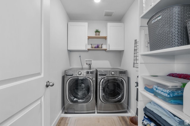 943 E Drifter Ln, Saratoga Springs, UT 84045 - laundry room featuring independent washer and dryer, wood finished floors, and cabinet space