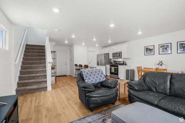 943 E Drifter Ln, Saratoga Springs, UT 84045 - living room featuring stairs, light wood-style floors, and recessed lighting