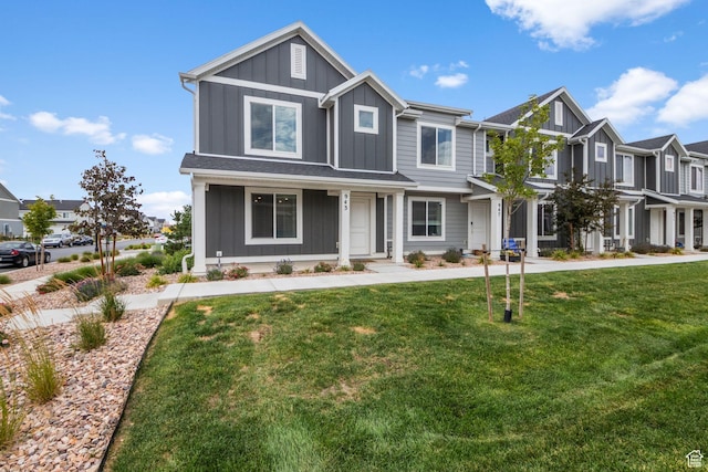 943 E Drifter Ln, Saratoga Springs, UT 84045 - view of front of property with board and batten siding, a front lawn, and a residential view