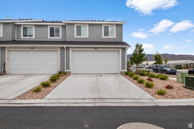 943 E Drifter Ln, Saratoga Springs, UT 84045 - traditional-style home with driveway, a mountain view, a garage, and stucco siding